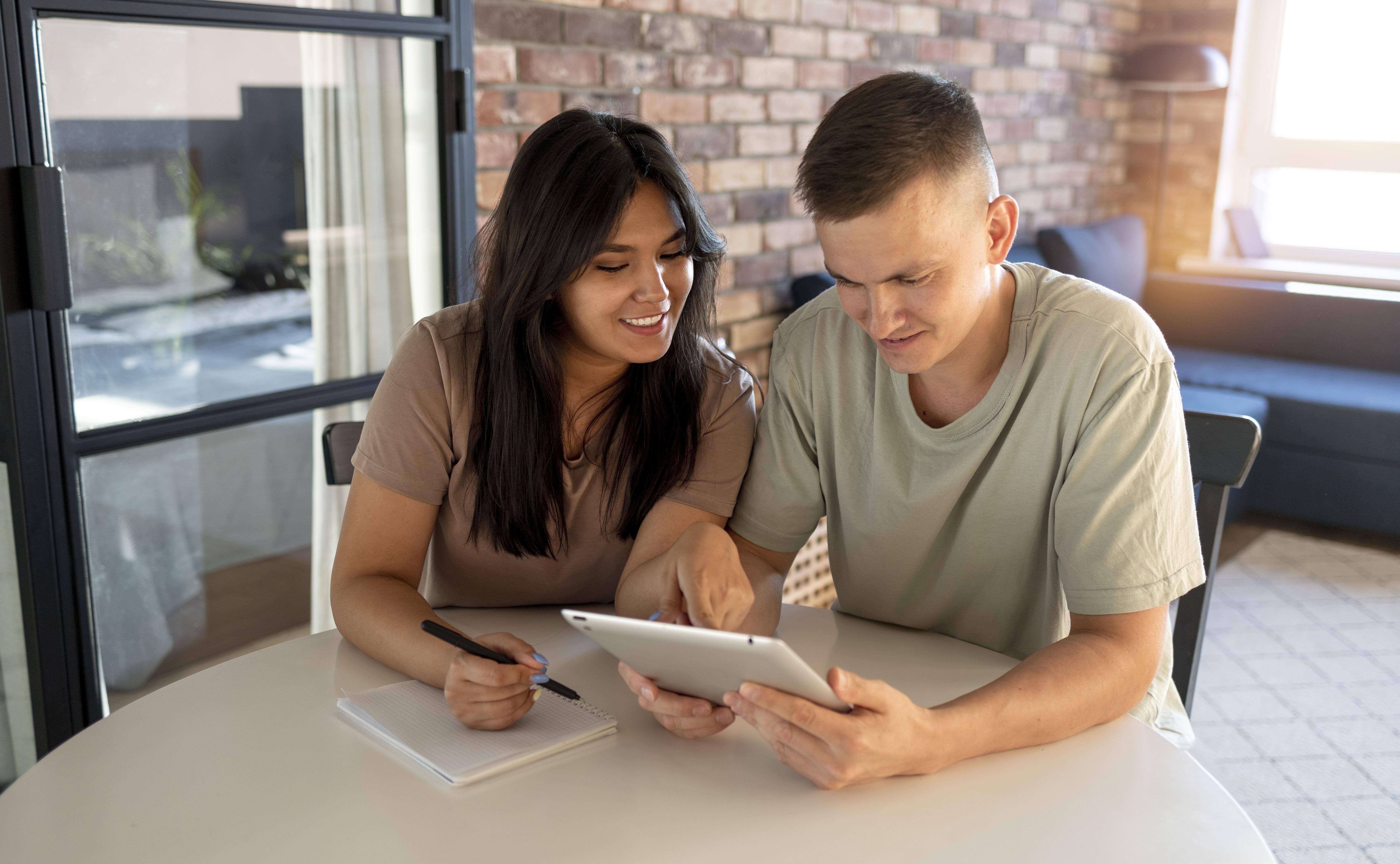 man-woman-making-shopping-list-with-tablet-1